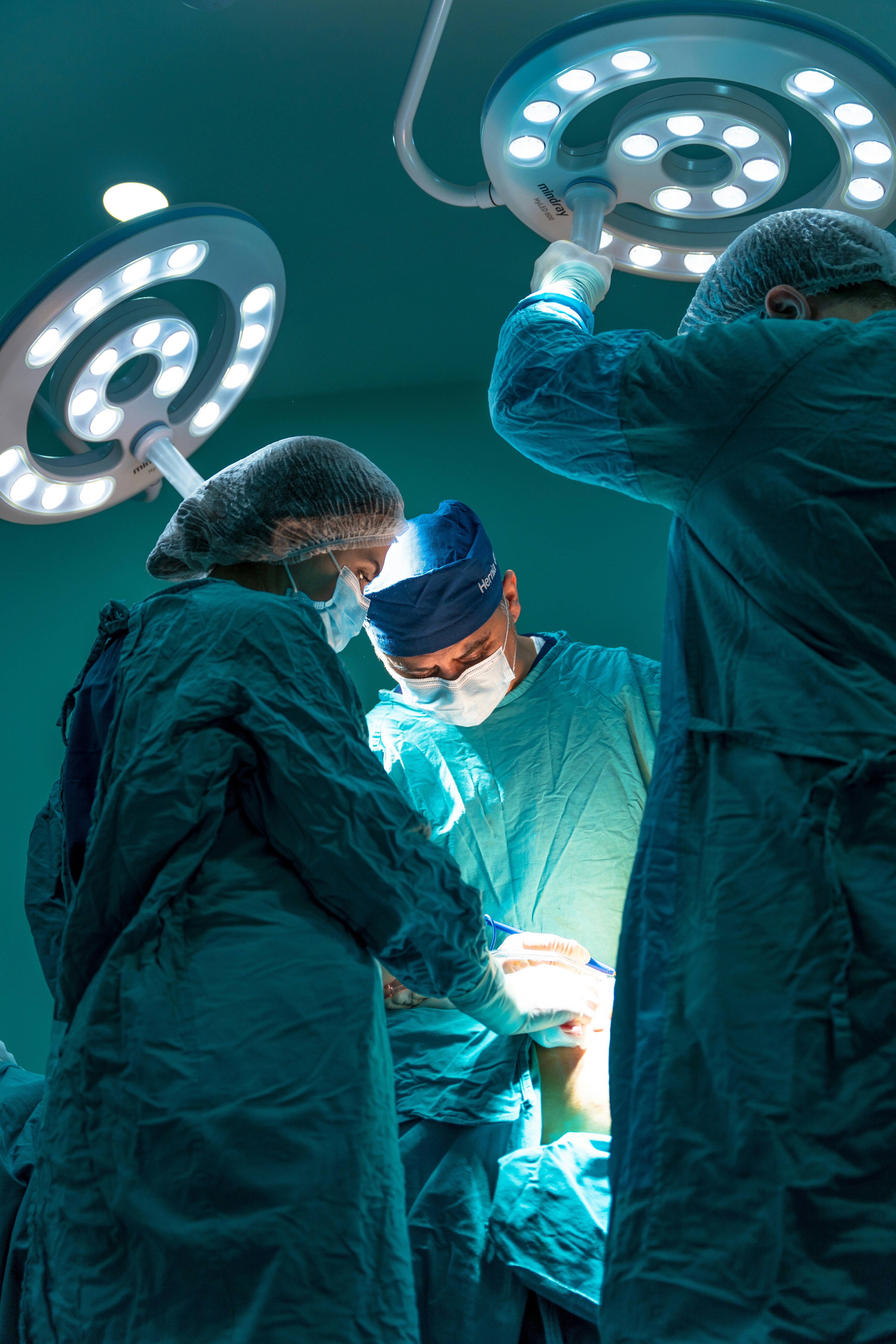 Surgical team operating under bright OR lights
